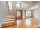 Two-story entryway with hardwood floors, elegant staircase, and double doors at 7954 Bay Pointe Dr, Denver, NC 28037