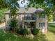 Brick house back with patio, deck, and stairs leading to a grassy yard at 7954 Bay Pointe Dr, Denver, NC 28037