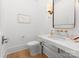 Elegant powder room, featuring marble vanity and gold fixtures at 1446 Queens W Rd, Charlotte, NC 28207