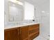 Modern bathroom with wood vanity and a walk-in shower at 1446 Queens W Rd, Charlotte, NC 28207