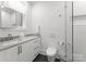 Clean bathroom with white vanity, marble countertop, and shower at 1446 Queens W Rd, Charlotte, NC 28207