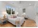 Bright bedroom with a queen-size bed and natural light at 1446 Queens W Rd, Charlotte, NC 28207