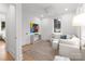 Spacious common area with a comfy couch and large art piece at 1446 Queens W Rd, Charlotte, NC 28207