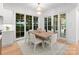 Charming dining area features a light wood table and access to backyard at 1446 Queens W Rd, Charlotte, NC 28207