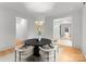 Bright dining room with modern chandelier and seating for four at 1446 Queens W Rd, Charlotte, NC 28207