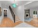 Bright entryway with hardwood floors, staircase, and chandelier at 1446 Queens W Rd, Charlotte, NC 28207