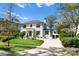 Stunning two-story home with white brick exterior, landscaping, and driveway at 1446 Queens W Rd, Charlotte, NC 28207