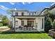 Covered patio with seating area, fireplace, and built-in ceiling fan at 1446 Queens W Rd, Charlotte, NC 28207