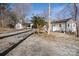 White house with gravel driveway and trees at 3305 Cameo Trl, Gastonia, NC 28056