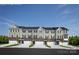 Front view of townhouses with attached garages and landscaping at 411 Moondance Dr, Gastonia, NC 28054