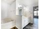 Bright bathroom with soaking tub, white vanity, double sinks, and modern fixtures at 416 Linsbury Ct, Gastonia, NC 28056