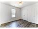 A bright bedroom featuring wood-look flooring and a large window for ample natural light at 416 Linsbury Ct, Gastonia, NC 28056