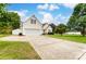 Charming two-story home with a well-manicured lawn, a two car garage, and a long driveway at 416 Linsbury Ct, Gastonia, NC 28056