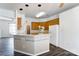 A bright kitchen features wood cabinets, modern appliances, and a tiled breakfast bar at 416 Linsbury Ct, Gastonia, NC 28056