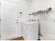 A dedicated laundry area with a dryer, overhead shelving, and convenient access to the outdoors at 416 Linsbury Ct, Gastonia, NC 28056