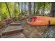 Scenic backyard with stone steps, landscaping, and a kayak at 156 Marietta Rd, Mooresville, NC 28117