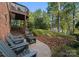 Serene backyard patio area with Adirondack chairs and landscaped garden at 156 Marietta Rd, Mooresville, NC 28117