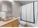 Neutral bathroom featuring a toilet, sink, framed mirror, and a white shower curtain with blue trim at 156 Marietta Rd, Mooresville, NC 28117