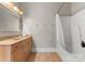 Neutral bathroom featuring a bathtub, shower, toilet, wood vanity and a framed mirror at 156 Marietta Rd, Mooresville, NC 28117