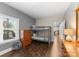 Bedroom with a bunk bed, a large window, and a dresser with gray and tan color scheme at 156 Marietta Rd, Mooresville, NC 28117