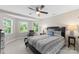 Cozy bedroom showcasing natural light, a ceiling fan, and a comfortable bed with striped bedding at 156 Marietta Rd, Mooresville, NC 28117