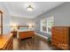 Cozy bedroom with natural light, warm wood furniture, and neutral wall colors at 156 Marietta Rd, Mooresville, NC 28117