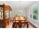 Formal dining room with large windows, hardwood floors, and elegant furniture at 156 Marietta Rd, Mooresville, NC 28117