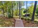 Wood path through trees leads to the dock with scenic lake views at 156 Marietta Rd, Mooresville, NC 28117