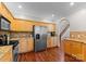 Well-lit kitchen featuring stainless steel appliances, granite countertops, and rich wood flooring at 156 Marietta Rd, Mooresville, NC 28117