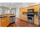 Functional kitchen featuring stainless steel appliances, granite counters, and wooden cabinetry at 156 Marietta Rd, Mooresville, NC 28117