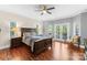 A spacious main bedroom with a wooden bed frame, hardwood floors, and natural light at 156 Marietta Rd, Mooresville, NC 28117