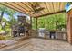 Gorgeous outdoor kitchen with stone fireplace, grill, and granite countertops at 156 Marietta Rd, Mooresville, NC 28117