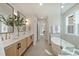 Bathroom featuring a freestanding tub, walk-in glass shower and double vanity sinks at 2621 Ritz Ln, Matthews, NC 28105