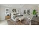 Bright bedroom with large windows, vaulted ceiling, patterned rug, and accent decor at 2621 Ritz Ln, Matthews, NC 28105