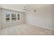 Bright bedroom with plush carpeting, large windows, and neutral color palette at 2621 Ritz Ln, Matthews, NC 28105