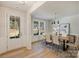 Bright dining room with a modern chandelier, wood table, and large windows at 2621 Ritz Ln, Matthews, NC 28105