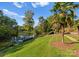 Picturesque lake view with a private dock, lush landscaping, and mature trees for a serene outdoor setting at 4145 Cindy Ln, Denver, NC 28037