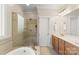 Bathroom featuring a tub, tiled shower with glass door, vanity, and tile flooring at 4145 Cindy Ln, Denver, NC 28037