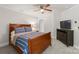 Comfortable bedroom showcasing a ceiling fan, plush bedding, and a dresser for storage at 4145 Cindy Ln, Denver, NC 28037