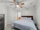 Bright bedroom featuring a ceiling fan, a comfortable bed, and two closets for ample storage at 4145 Cindy Ln, Denver, NC 28037