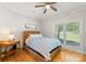Cozy bedroom with a neutral color palette, a woven headboard bed, and natural light from the window at 4145 Cindy Ln, Denver, NC 28037