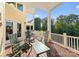 Covered porch offering beautiful views with rocking chairs and a table for outdoor enjoyment at 4145 Cindy Ln, Denver, NC 28037