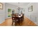Bright dining room boasts hardwood floors, a chandelier, and large windows offering scenic outdoor views at 4145 Cindy Ln, Denver, NC 28037