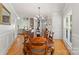 Formal dining room view showcasing hardwood floors, adjacent living space with fireplace, and abundant natural light at 4145 Cindy Ln, Denver, NC 28037
