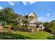 Sprawling home on a lush green lawn with mature landscaping and dual outdoor balconies at 4145 Cindy Ln, Denver, NC 28037