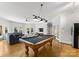Spacious game room with a pool table, seating area, and natural light from the doors at 4145 Cindy Ln, Denver, NC 28037