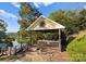 Wooden gazebo next to the lake featuring decorative sun accent and brick path at 4145 Cindy Ln, Denver, NC 28037