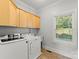 Well-lit laundry room with modern washer and dryer, cabinetry, utility sink, and window at 4145 Cindy Ln, Denver, NC 28037
