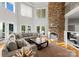 Bright living room featuring a stone fireplace, hardwood floors and a comfortable sectional sofa at 4145 Cindy Ln, Denver, NC 28037