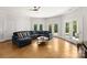 Spacious living room featuring a large sectional sofa, tile flooring, and multiple doors to the outside at 4145 Cindy Ln, Denver, NC 28037